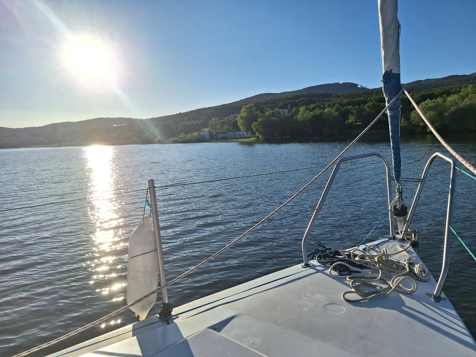 Freya's foredeck under way, low sun over the water