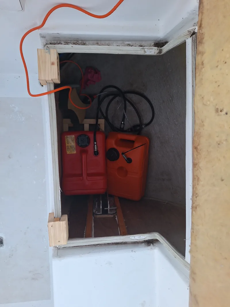 Fuel tanks stowed in a cockpit locker
